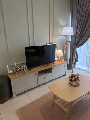 a living room with a flat screen tv on a entertainment center at Razak Residence KL Area Cozy & Simple RC B2 18 in Kuala Lumpur