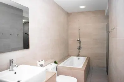 a bathroom with a sink and a tub and a toilet at MyHabitat Residences in Kuala Lumpur