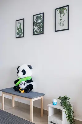 a stuffed panda bear sitting on a table in a room at Kuala Lumpur Skyline CityView Comfort Home in Kuala Lumpur