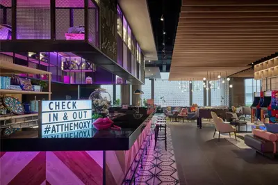 a restaurant with a check in and out at the moment at Moxy Kuala Lumpur Chinatown in Kuala Lumpur