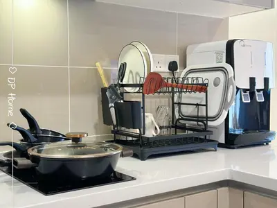 a kitchen counter with a drying rack with many kitchen utensils at 5 STAR Homestay 3R3B KL View Trion TRX Velocity in Kuala Lumpur