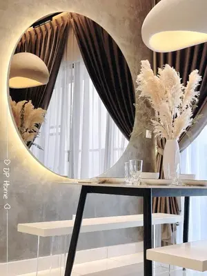 a round mirror above a table with glasses and vases at 5 STAR Homestay 3R3B KL View Trion TRX Velocity in Kuala Lumpur