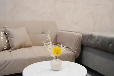 a vase with a yellow flower on a table in a living room at Studio KL Trion for 2-3 pax KL TRX Velocity in Kuala Lumpur