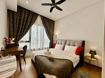 a bedroom with a bed and a desk and a window at Stylish Apartment at Lucentia residence BBCC Lalaport in Kuala Lumpur