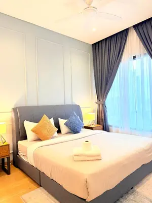 a bedroom with a bed with pillows and a window at Stylish Apartment at Lucentia residence BBCC Lalaport in Kuala Lumpur
