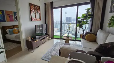 a living room with a tv and a large window at The BirdsEye View facing KLCC with Gorgeous pools in Kuala Lumpur