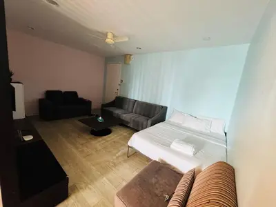 a small room with a bed and a couch at Taragon Standard Homestay in Kuala Lumpur