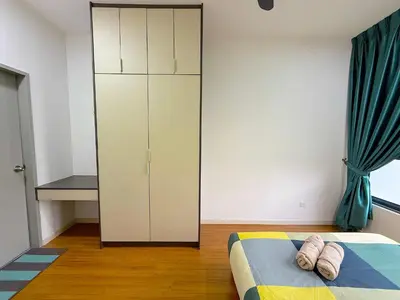 a bedroom with a white cabinet and a bed at M Vertica Cheras by RASBO Galaxy Suites in Kuala Lumpur
