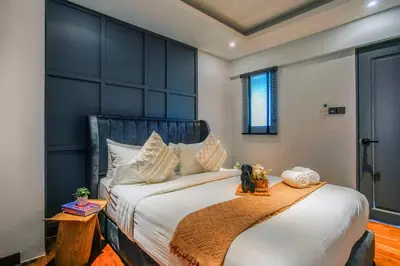 a bedroom with a large bed with a blue headboard at Novo Ampang, Luxury Premium 3BR Penthouse, Kuala Lumpur by Cobnb in Kuala Lumpur