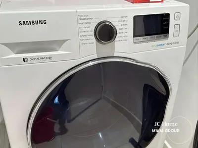 a white washing machine with its door open at The Anggun l 5-star Bathtub Suites By MWM in Kuala Lumpur