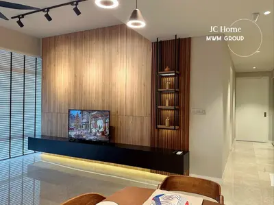 a living room with a tv on a wall at The Anggun l 5-star Bathtub Suites By MWM in Kuala Lumpur