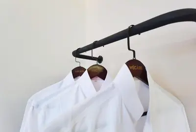 a group of white shirts hanging on a rack at Weekly Monthly Stay - Bangsar Trade Centre Curvena in Kuala Lumpur