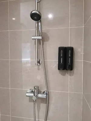 a shower in a bathroom with a shower head at Weekly Monthly Stay - Bangsar Trade Centre Curvena in Kuala Lumpur