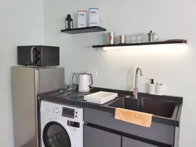 a kitchen with a sink and a washing machine at Weekly Monthly Stay - Bangsar Trade Centre Territory in Kuala Lumpur