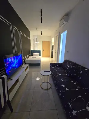 a living room with a couch and a tv at AXON Bukit Bintang Suites KL in Kuala Lumpur