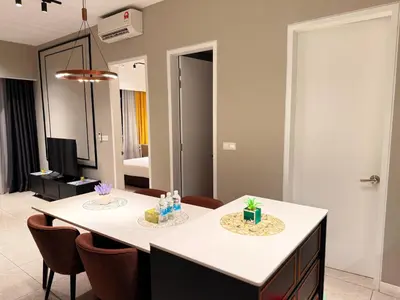 a dining room with a table and some chairs at Axon Residence Bukit Bintang by TaheeenS in Kuala Lumpur