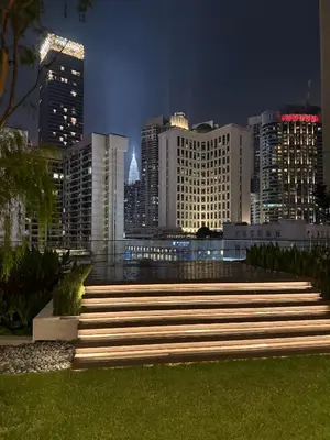 a set of stairs in front of a city at night at Axon Residence Bukit Bintang by TaheeenS in Kuala Lumpur