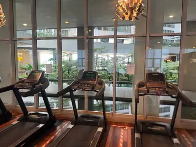a gym with two treadmills in a building at Infinity Skypool Ladies Room in Hostel in Kuala Lumpur