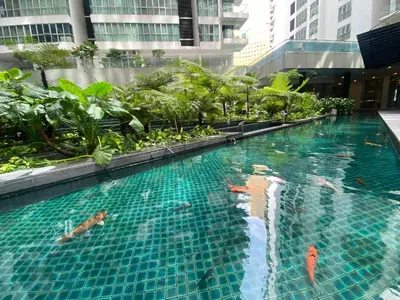 a swimming pool in the middle of a building at Infinity Skypool hostel in Kuala Lumpur