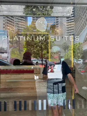 a man standing in front of a store window at The Platinum Kuala Lumpur by Skyscraper in Kuala Lumpur
