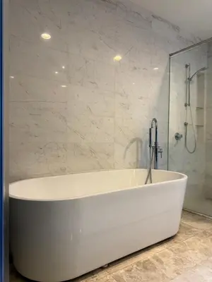 a white bath tub in a bathroom with a shower at The Platinum Kuala Lumpur by Skyscraper in Kuala Lumpur