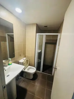 a bathroom with a toilet and a sink and a shower at Residence HomeStay in Kuala Lumpur