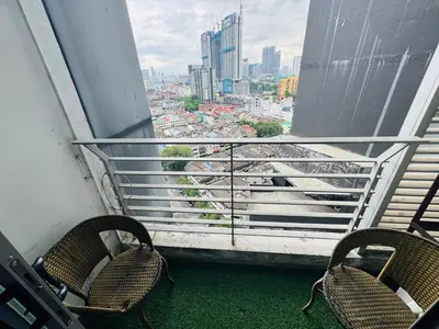 a balcony with two chairs and a view of a city at Residence HomeStay in Kuala Lumpur