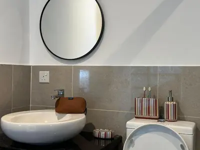 a bathroom with a sink and a mirror on the wall at Weekly Monthly Stay - Bangsar Trade Centre Benton in Kuala Lumpur