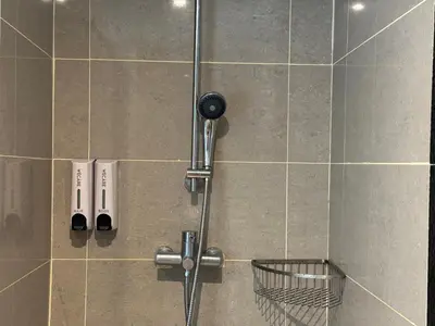 a shower with a shower head in a bathroom at Weekly Monthly Stay - Bangsar Trade Centre Benton in Kuala Lumpur