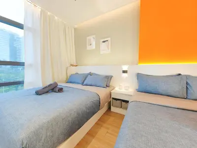 a bedroom with two beds and a window at Weekly Monthly Stay - Bangsar Trade Centre Aspire in Kuala Lumpur