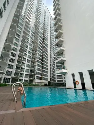 a swimming pool in front of a large building at Elevated Horizons Hostel & Infinity Suites Skypool in Kuala Lumpur