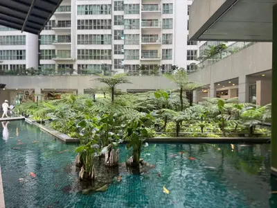 a large pool of water with trees in a building at Kuala Lumpur Infinity Skypool hostel in Kuala Lumpur