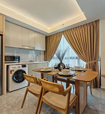 a kitchen with a table and chairs and a microwave at Residensi Agile Delima by Times 8 in Kuala Lumpur