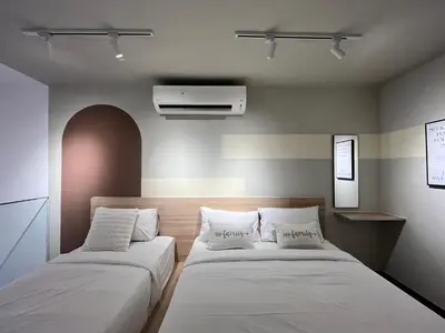 a bedroom with two beds with white pillows at Residensi Agile Delima by Times 8 in Kuala Lumpur