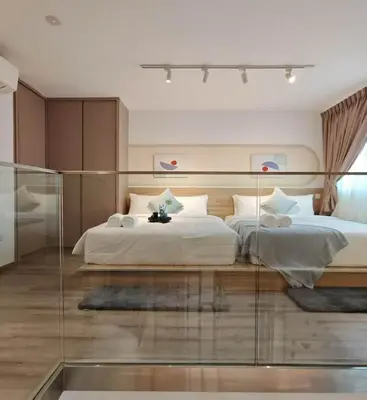 a bedroom with a large bed with a glass wall at Residensi Agile Delima by Times 8 in Kuala Lumpur