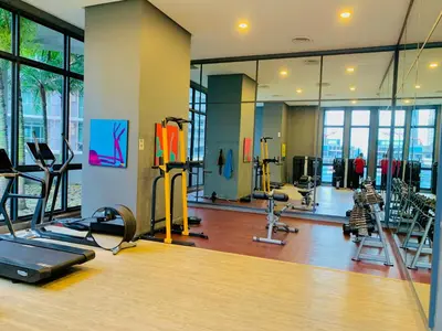 a gym with treadmills and machines in a room at The MEWS KLCC By Arman in Kuala Lumpur