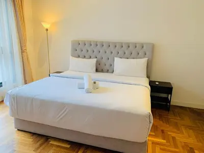 a bedroom with a large white bed with a box on it at The Mews KLCC By SKY GARDEN in Kuala Lumpur