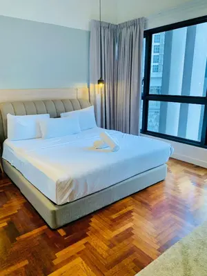 a bedroom with a white bed with a large window at The Mews KLCC By SKY GARDEN in Kuala Lumpur
