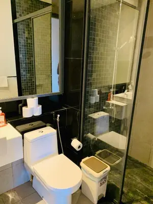 a bathroom with a toilet and a glass shower at The Mews KLCC By SKY GARDEN in Kuala Lumpur