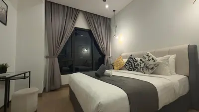 a bedroom with a bed with pillows and a window at Lucentia Residences by Luxe Suites in Bukit Bintang KLCC! in Kuala Lumpur