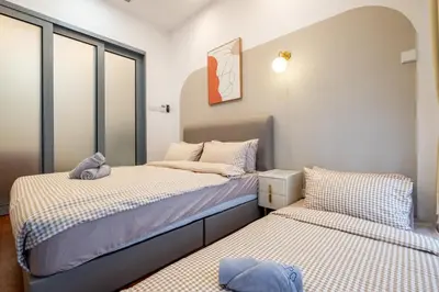 two beds in a room with windows at Le Luxe de KL 2BR with Bath Tub 10 min to KLCC in Kuala Lumpur