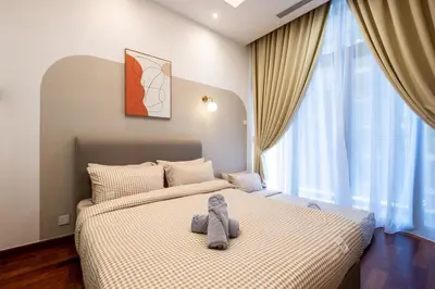 a bedroom with a bed with a stuffed animal on it at Le Luxe de KL 2BR with Bath Tub 10 min to KLCC in Kuala Lumpur