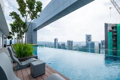a swimming pool on top of a building with a city at Le Luxe de KL 2BR with Bath Tub 10 min to KLCC in Kuala Lumpur