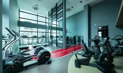 a gym with several cardio machines in a room at 03 Tribeca Serviced Suites I 5 min to Pavilion KL I 2R1B I TRX Tower View in Kuala Lumpur