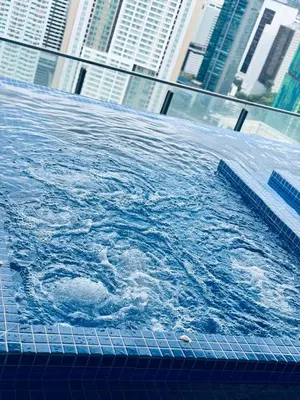 a large pool of water with buildings in the background at XING LUN KLCC The Colony Infinitum in Kuala Lumpur