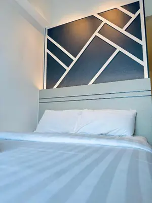 a bed with a white pillow in a room at XING LUN KLCC The Colony Infinitum in Kuala Lumpur