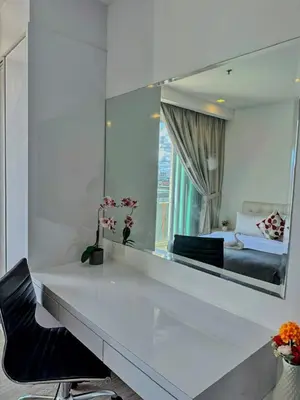 a bedroom with a large mirror and a bed at One Ceylon Suites By OHaus in Kuala Lumpur