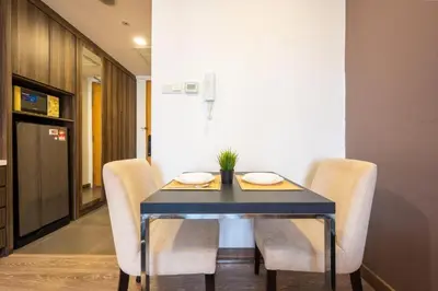 a dining room with a blue table and chairs at One Ceylon Suites By OHaus in Kuala Lumpur