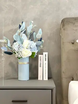 a vase of flowers on top of a table at Luxury Homestay KL Center 6-8pax TRX-Velocity-Ikea in Kuala Lumpur