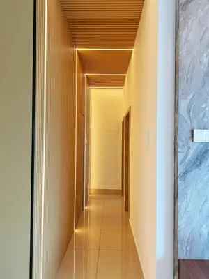 a hallway with yellow walls and a ceiling at D3911 Klcc View Private Roof Terrace l 8Pax in Kuala Lumpur